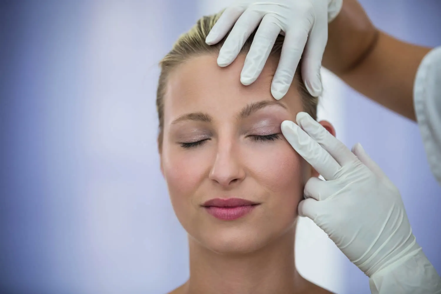 dermatologist-examining-female-patients-face-from-thermage-treatment